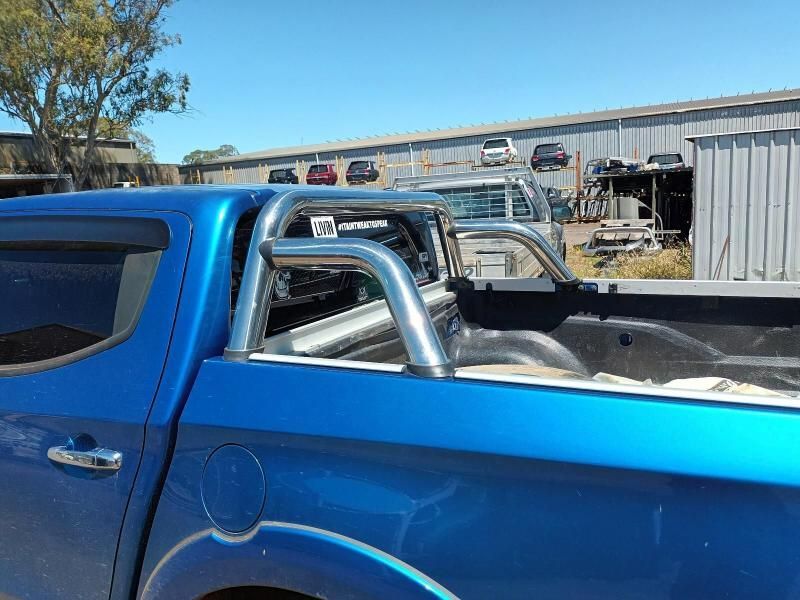 A Blue Truck is Parked in Front of a Building — South West 4WD Wreckers In Brisbane, QLD