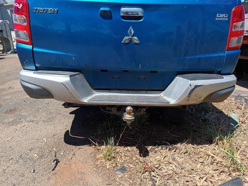 A Blue Mitsubishi Triton Truck is Parked in the Dirt — South West 4WD Wreckers In Brisbane, QLD