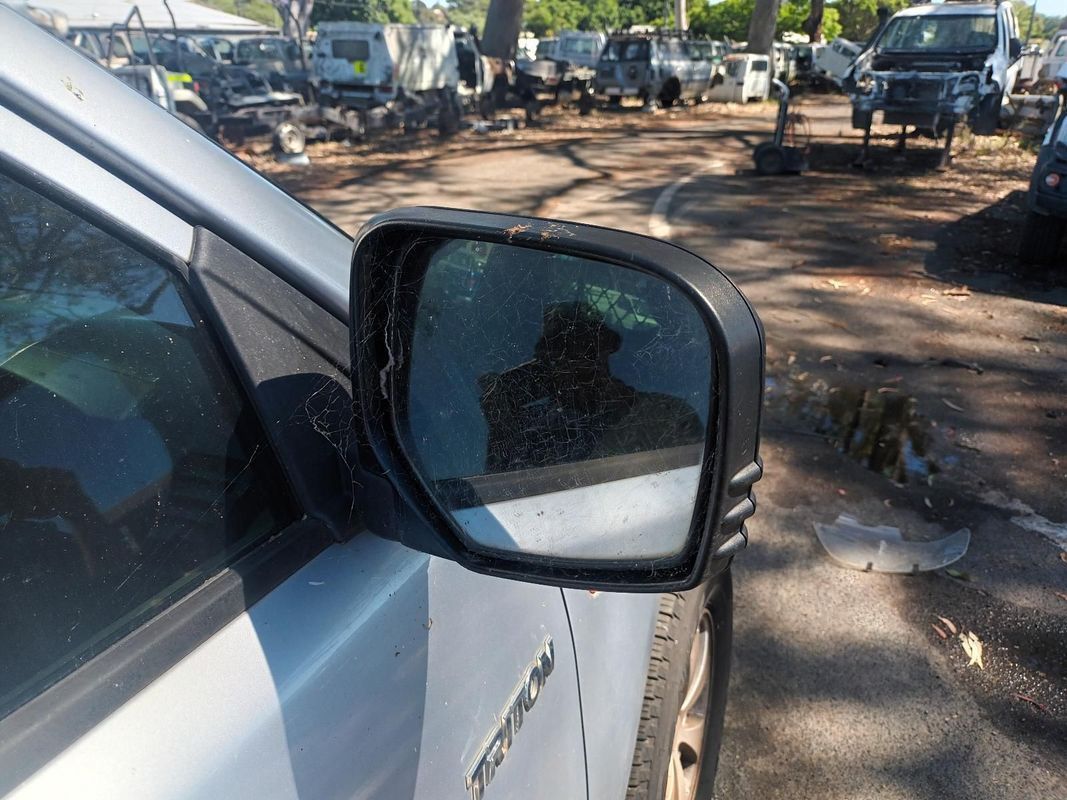 A Close Up of a Cars Side View Mirror in a Parking Lot — South West 4WD Wreckers In Brisbane, QLD