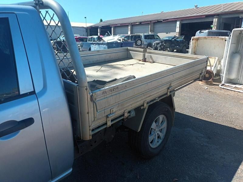 A Silver Truck With a Tray on the Back is Parked in a Parking Lot — South West 4WD Wreckers In Brisbane, QLD