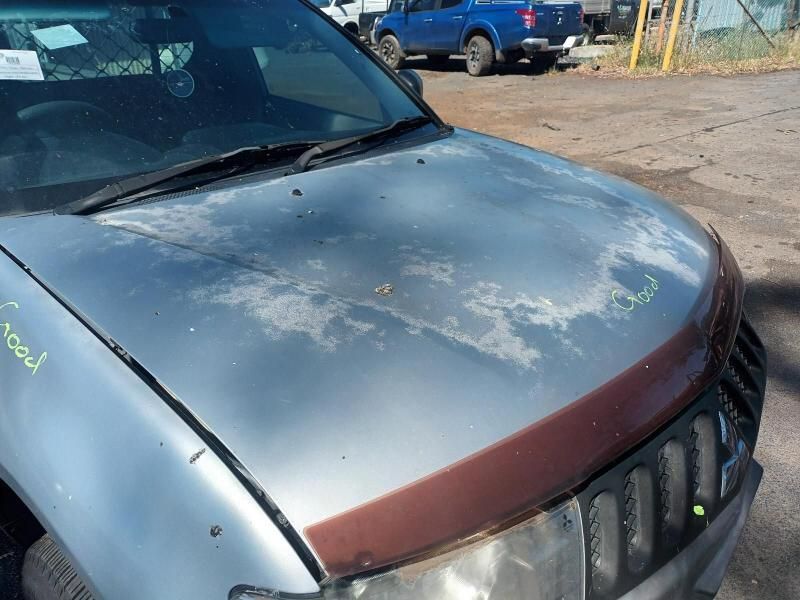 A Silver Car With a Hood That Has Been Damaged — South West 4WD Wreckers In Brisbane, QLD