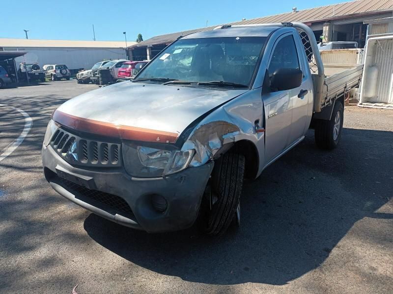 A Silver Truck is Parked in a Parking Lot in Front of a Building — South West 4WD Wreckers In Brisbane, QLD