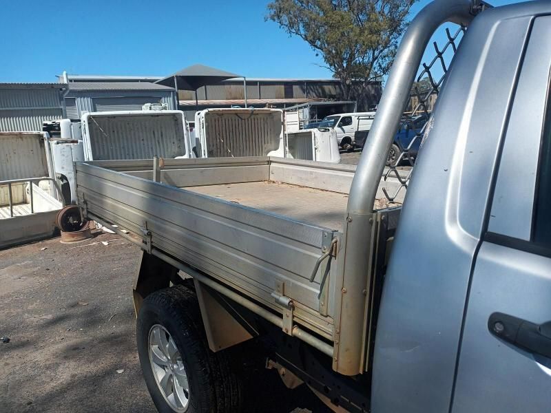 A Silver Truck With an Empty Bed is Parked in a Parking Lot — South West 4WD Wreckers In Brisbane, QLD
