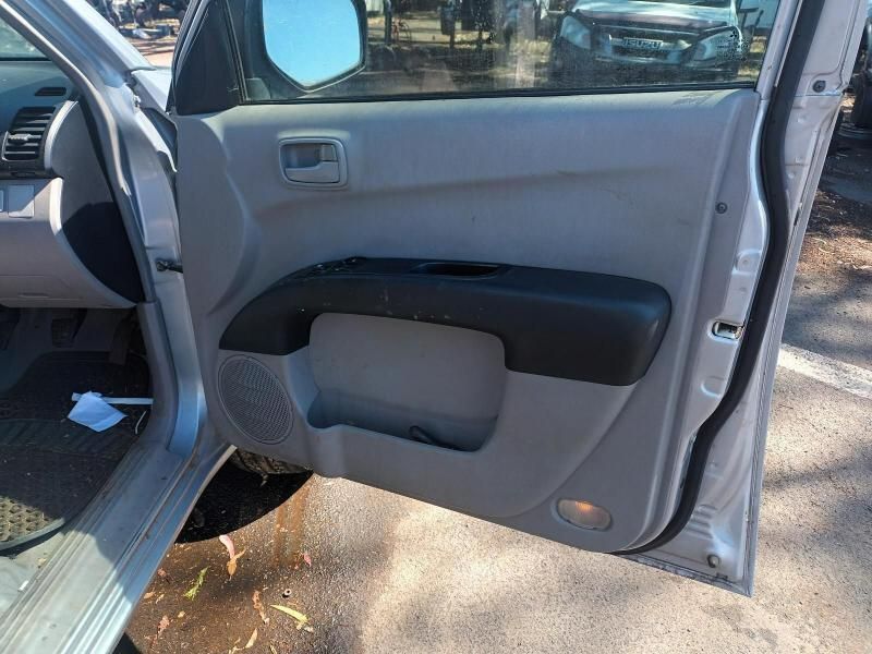 A Silver Car With the Door Open is Parked on the Side of the Road — South West 4WD Wreckers In Brisbane, QLD