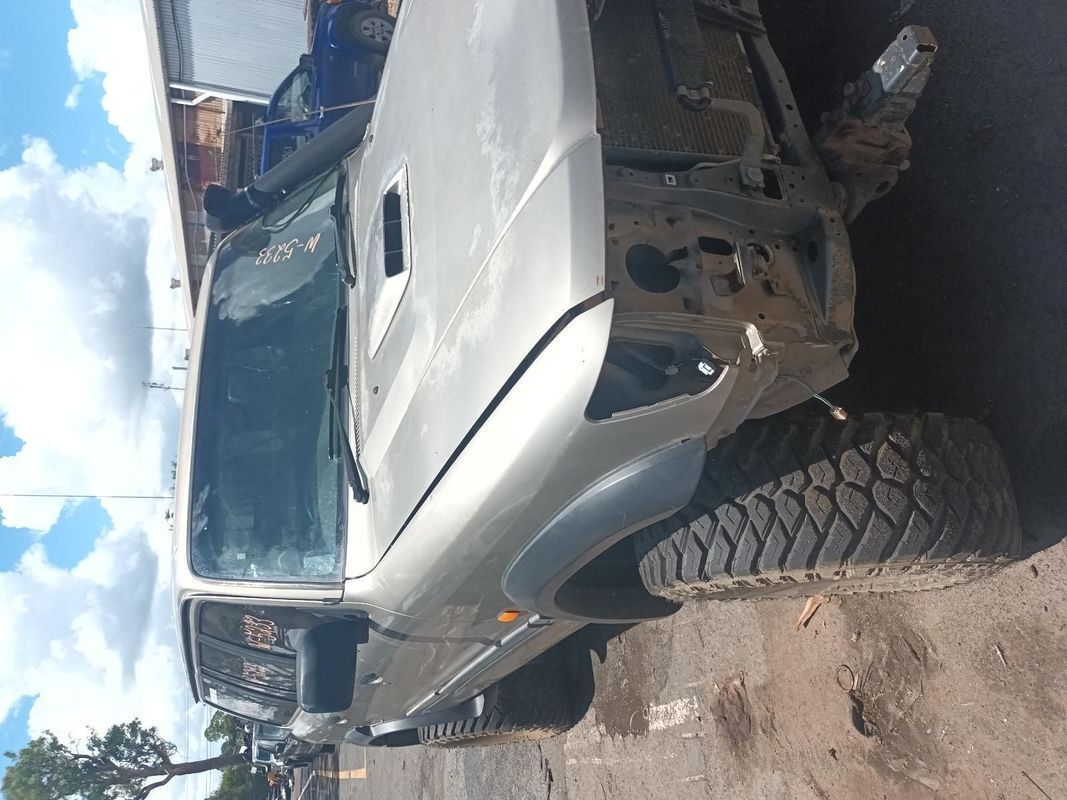 A Silver Truck is Parked on the Side of a Dirt Road — South West 4WD Wreckers In Brisbane, QLD