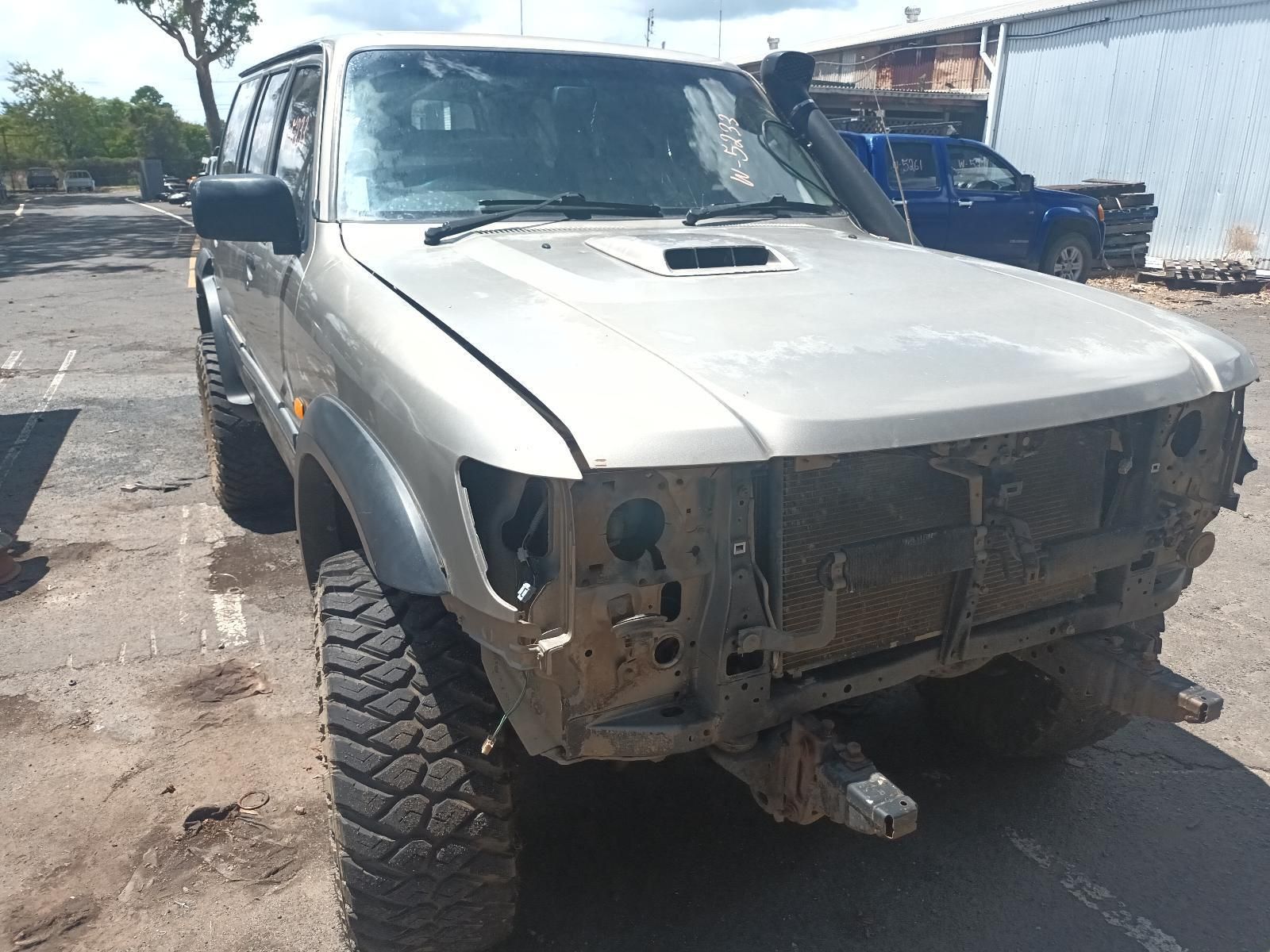 A Silver Truck with a Broken Hood is Parked in a Parking Lot — South West 4WD Wreckers In Brisbane, QLD