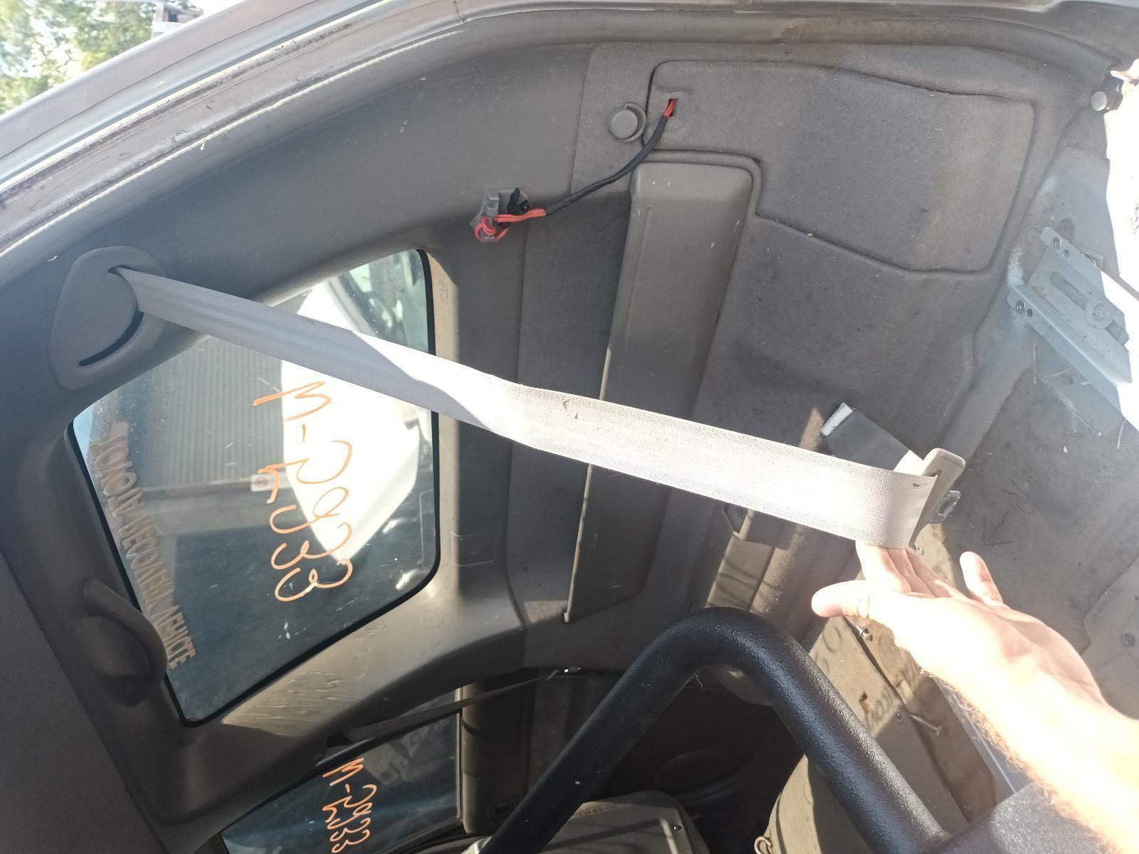A Person is Putting on a Seat Belt in a Car — South West 4WD Wreckers In Brisbane, QLD