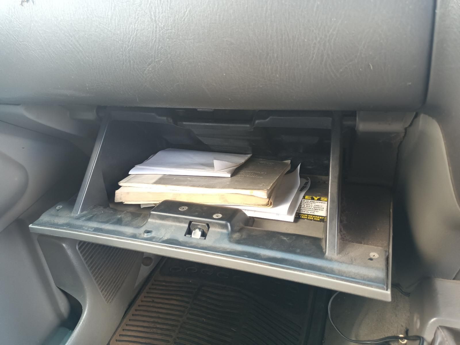 A Car Glovebox with a Book and Papers in It — South West 4WD Wreckers In Brisbane, QLD