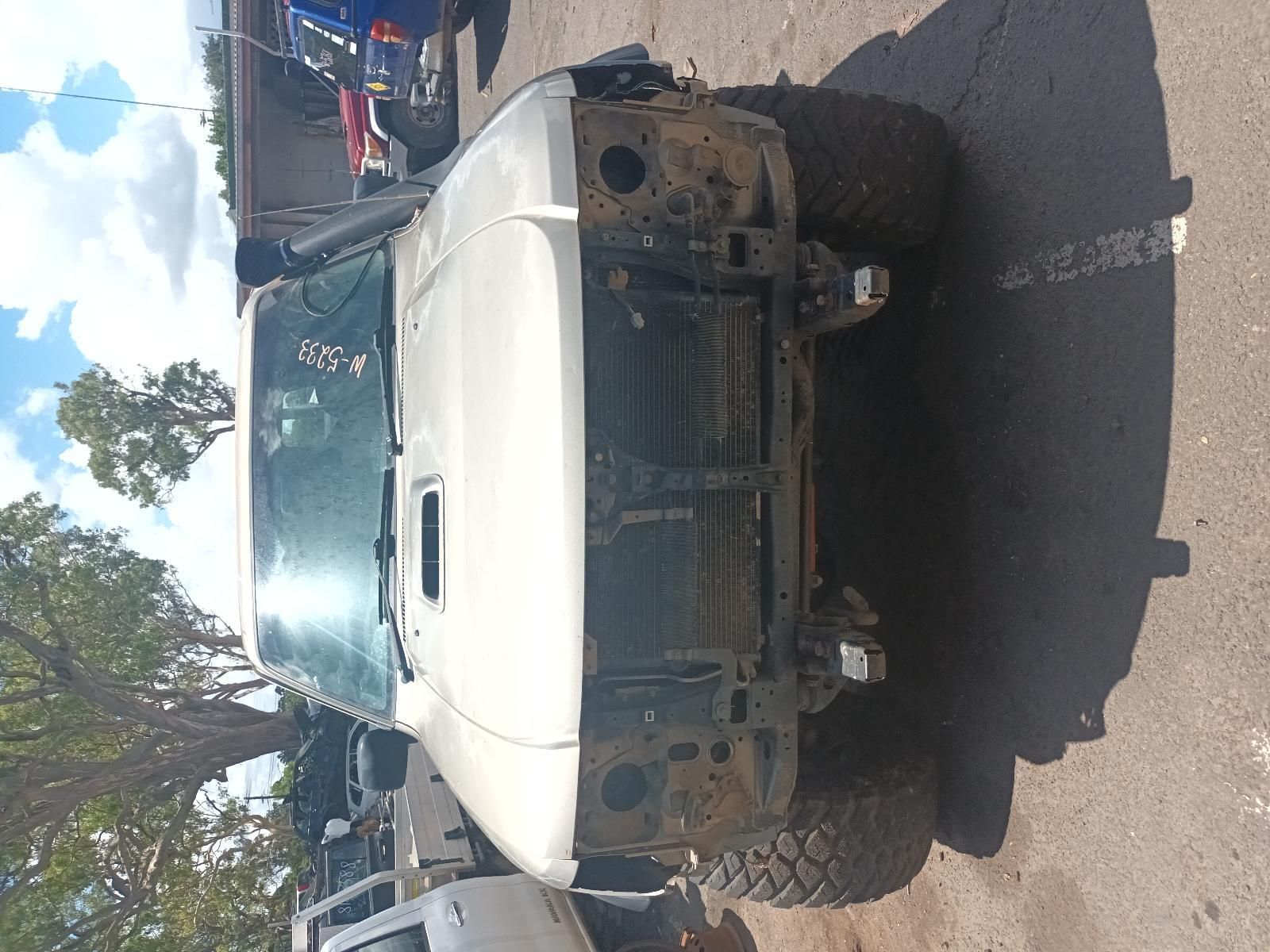 A White Truck is Sitting on the Side of the Road — South West 4WD Wreckers In Brisbane, QLD