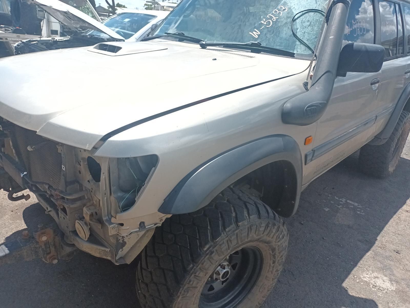A Car with the Hood Up is Parked on the Side of the Road — South West 4WD Wreckers In Brisbane, QLD