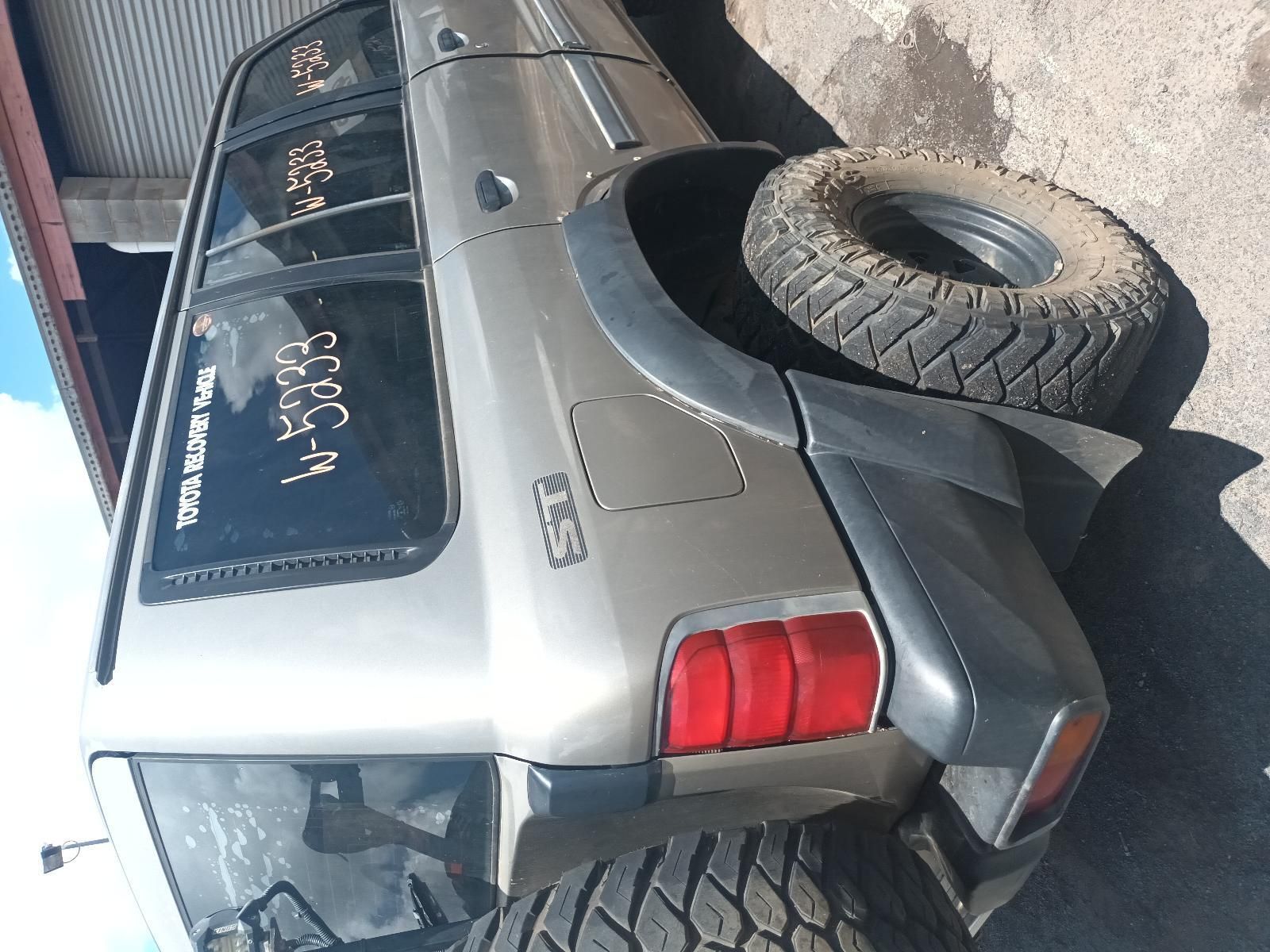 A Silver SUV is Parked on the Side of the Road Next to a Tire — South West 4WD Wreckers In Brisbane, QLD