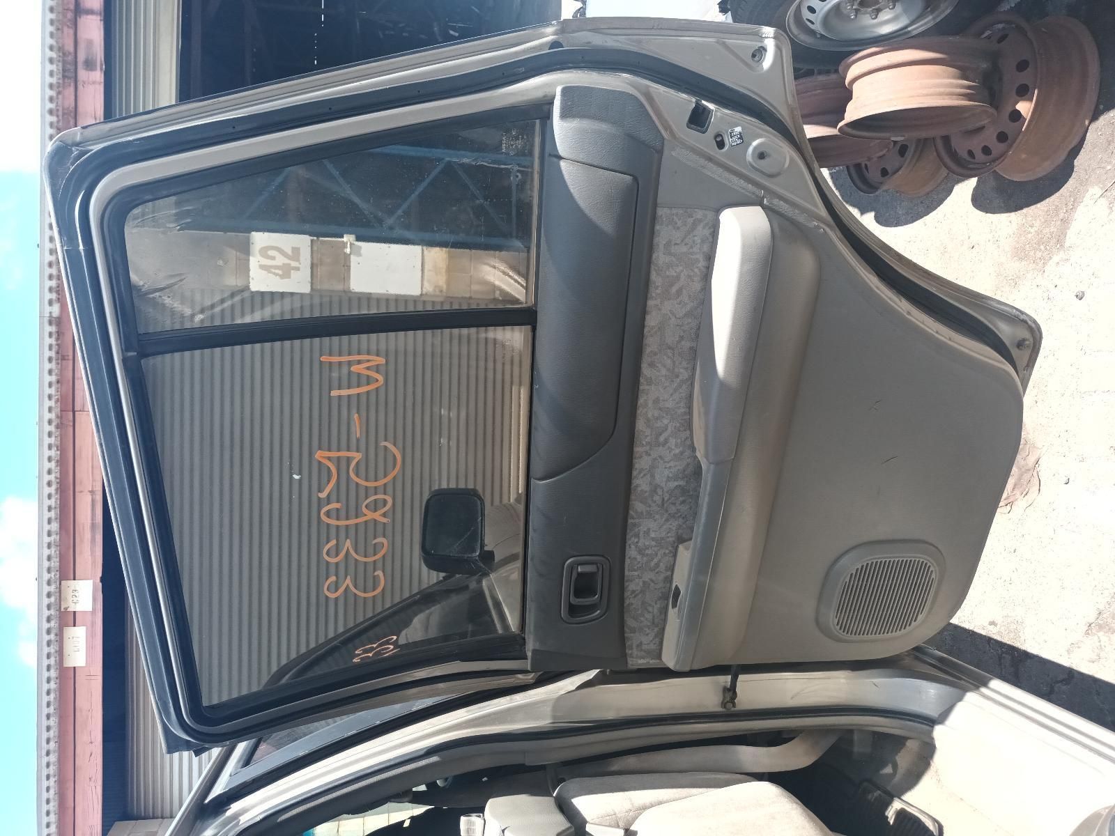 The Back Door of a Car is Open and Sitting in a Warehouse — South West 4WD Wreckers In Brisbane, QLD