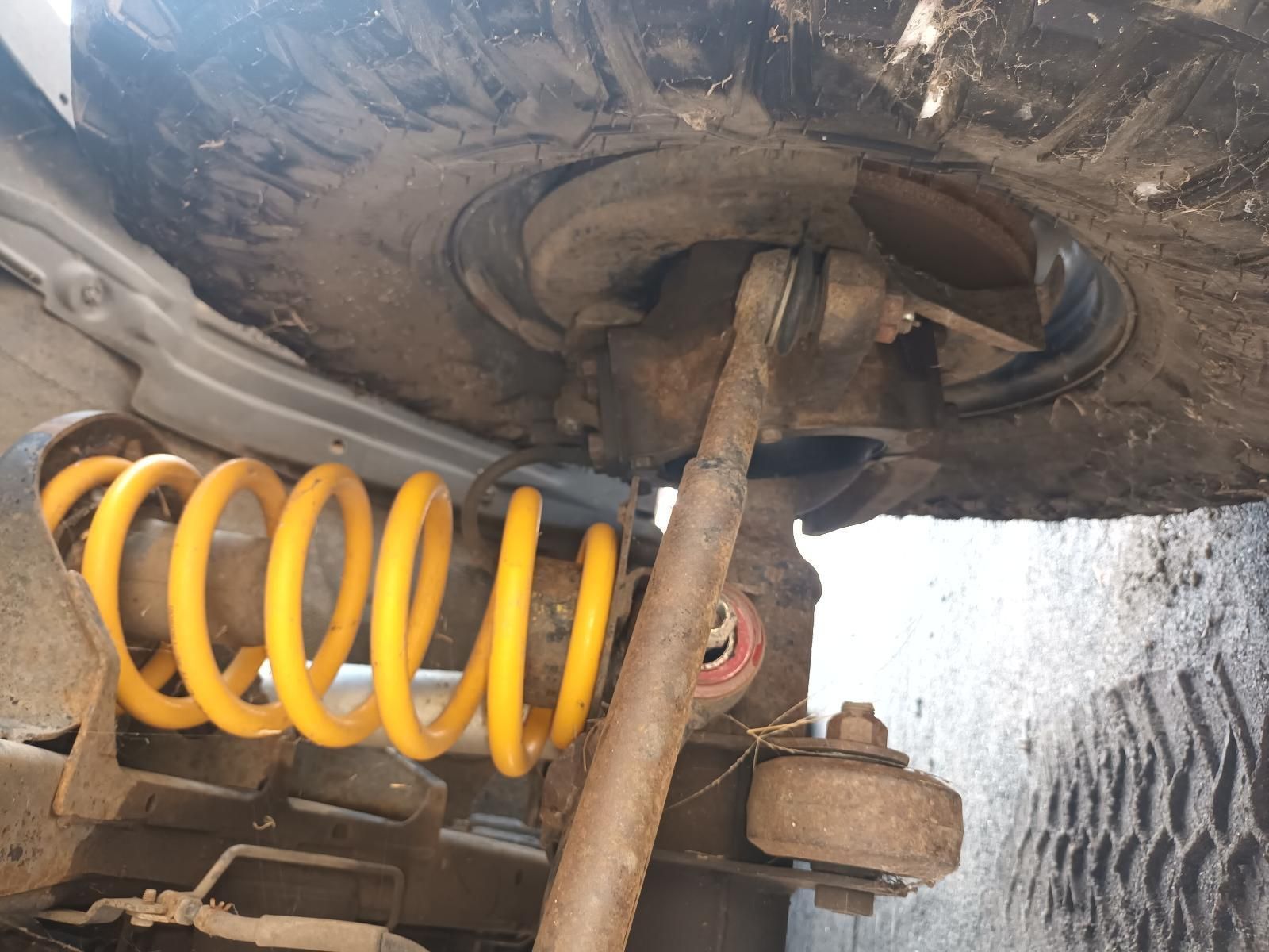 A Close Up of a Yellow Coil Spring on a Car — South West 4WD Wreckers In Brisbane, QLD
