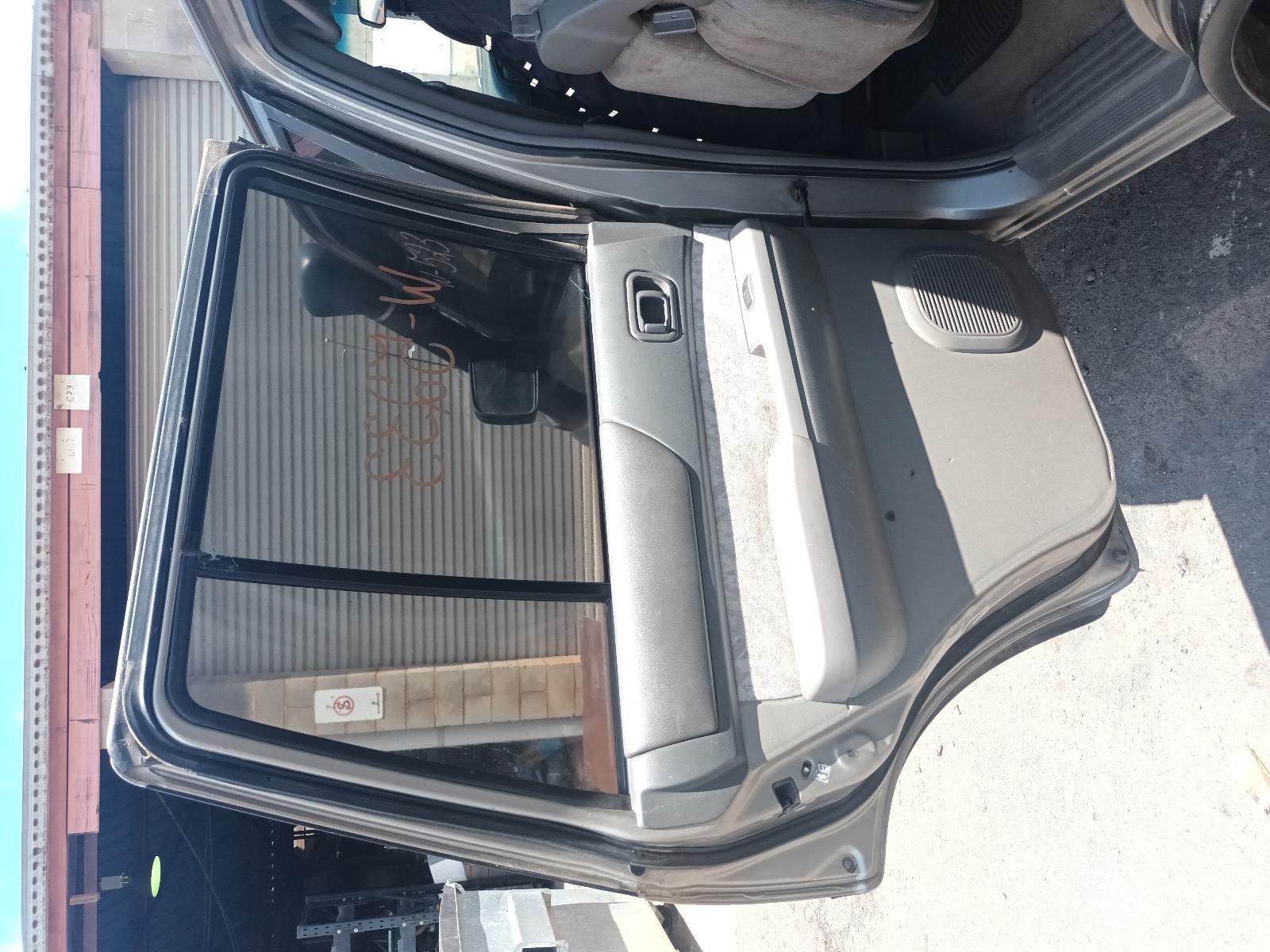 A Car with the Door Open is Parked in Front of a Garage — South West 4WD Wreckers In Brisbane, QLD