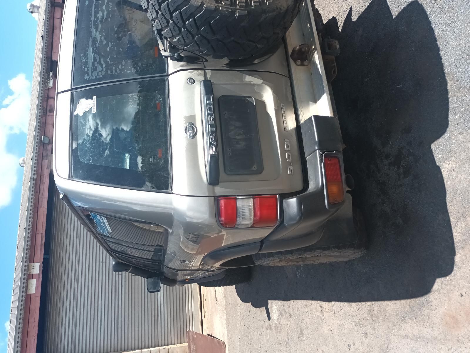 A Silver SUV is Parked in Front of a Garage — South West 4WD Wreckers In Brisbane, QLD