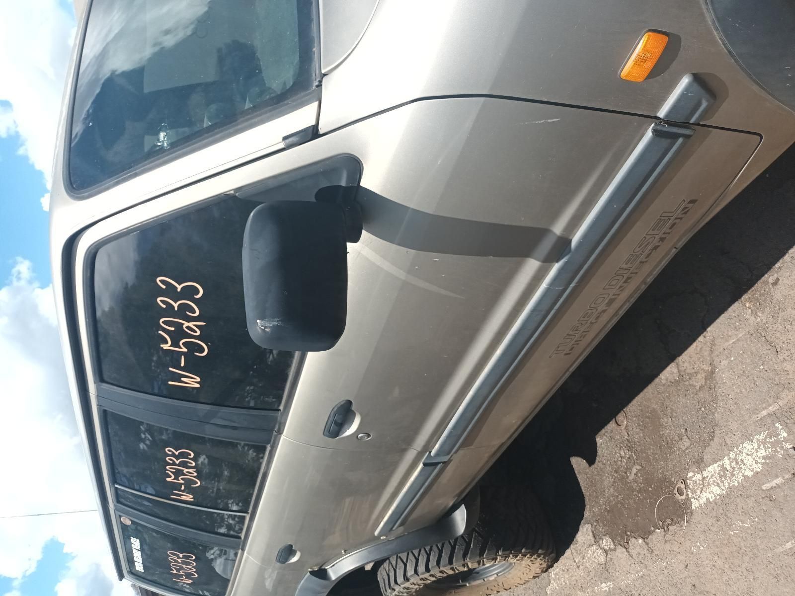 A Car with the License Plate N-5233 is Parked on the Side of the Road — South West 4WD Wreckers In Brisbane, QLD