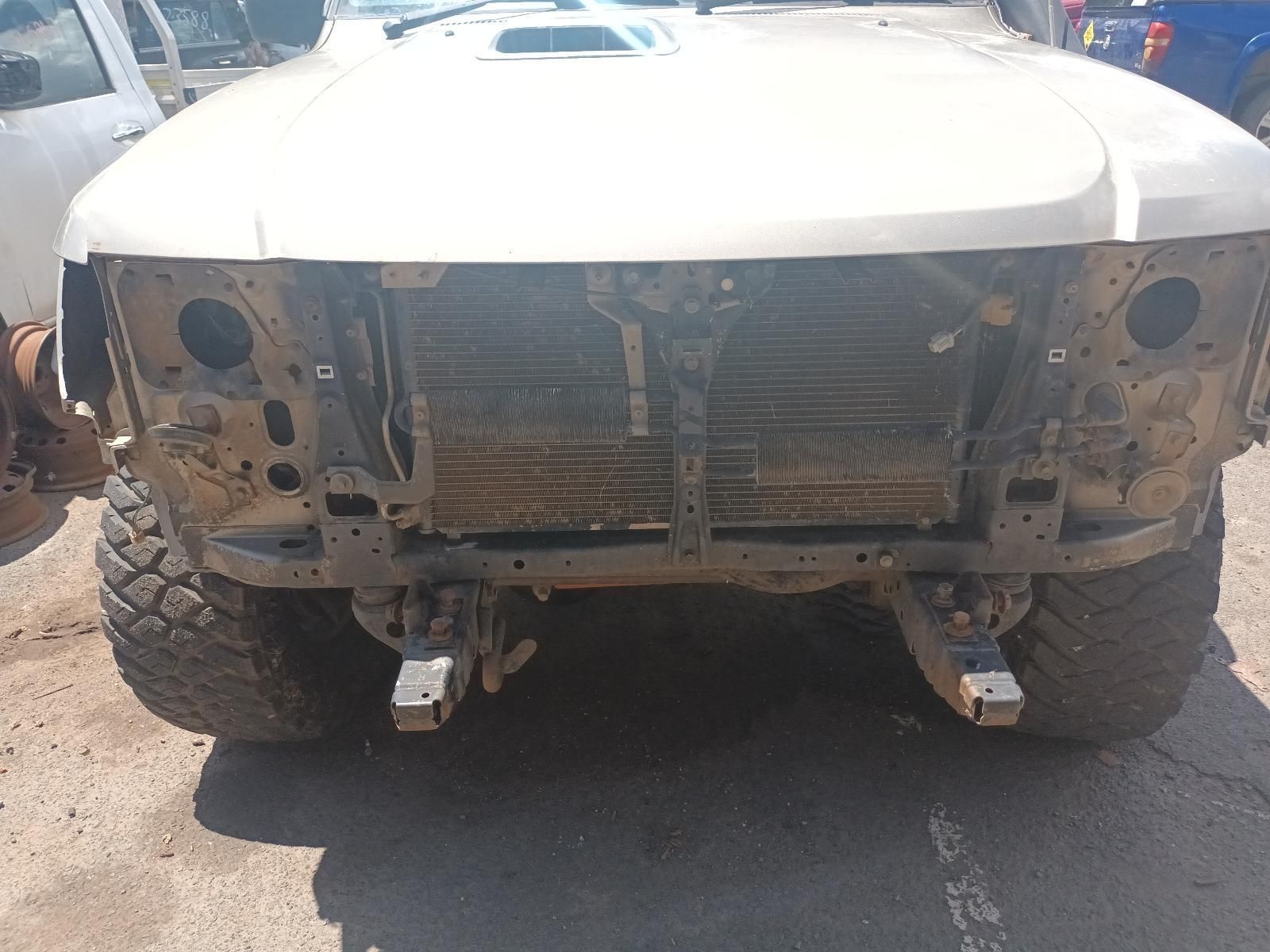 A White Truck with the Hood Removed is Parked on the Side of the Road — South West 4WD Wreckers In Brisbane, QLD