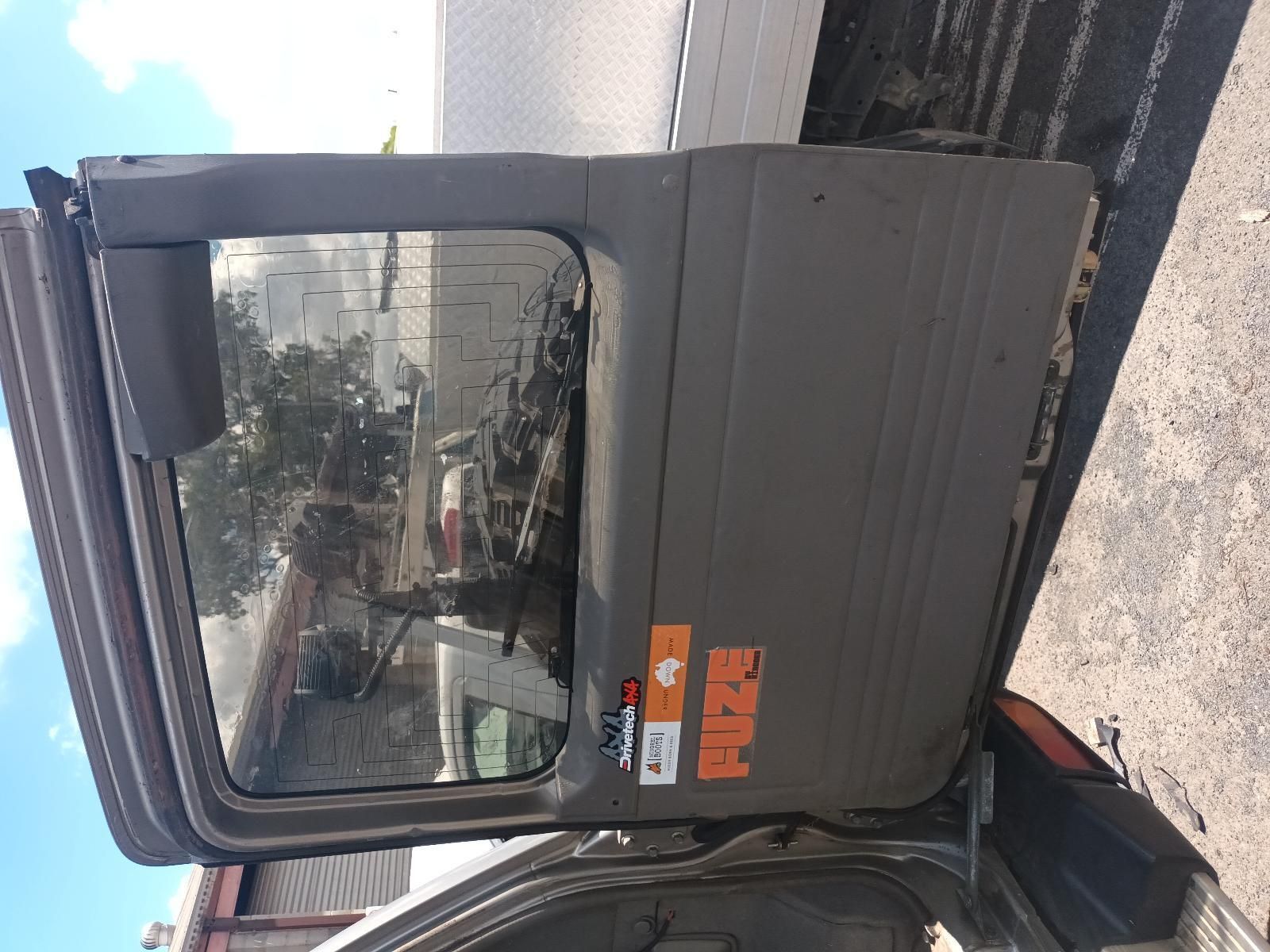 A Car with the Door Open is Parked on the Side of the Road — South West 4WD Wreckers In Brisbane, QLD