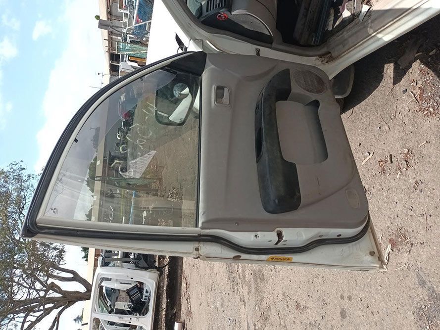 A White Car With Its Doors Open is Parked on a Dirt Road — South West 4WD Wreckers In Brisbane, QLD