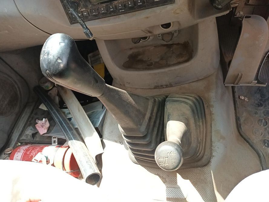 A Dirty Dashboard With a Fire Extinguisher on the Floor — South West 4WD Wreckers In Brisbane, QLD