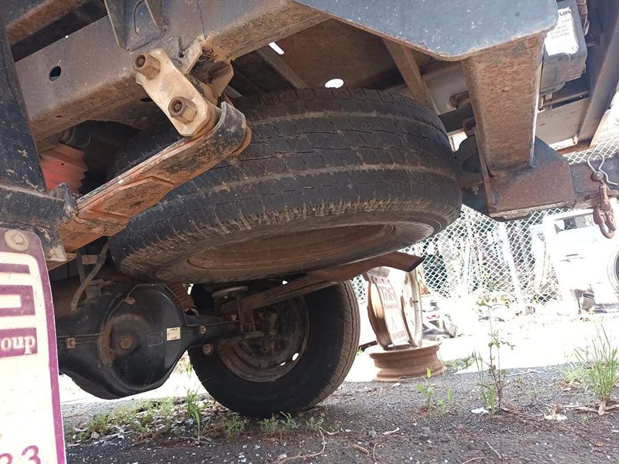 A Close Up of the Underside of a Truck With a Tire on It — South West 4WD Wreckers In Brisbane, QLD