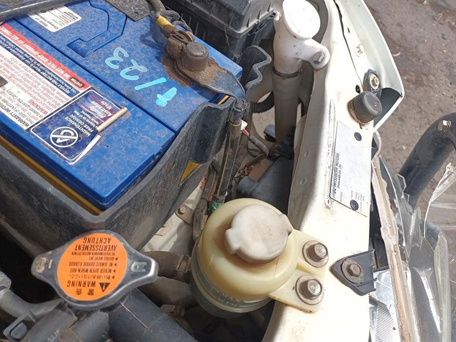 A Car With a Blue Battery That Says T123 on It — South West 4WD Wreckers In Brisbane, QLD