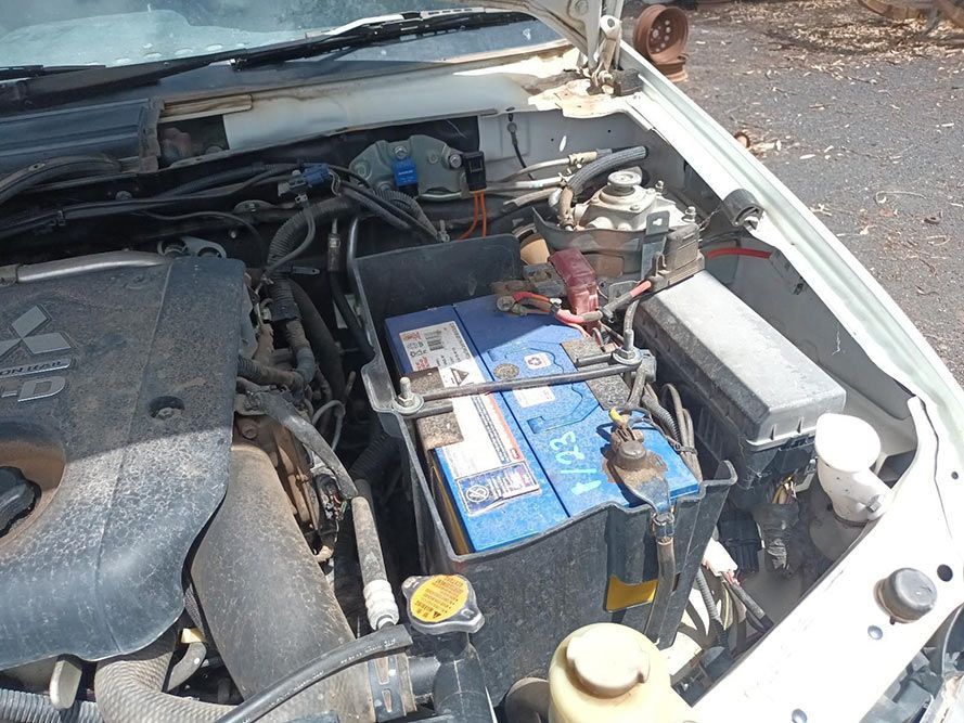 The Hood of a White Car With a Blue Battery in It — South West 4WD Wreckers In Brisbane, QLD