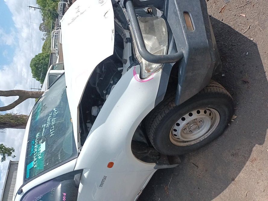 A White Truck With the Hood Up is Parked on the Side of the Road — South West 4WD Wreckers In Brisbane, QLD
