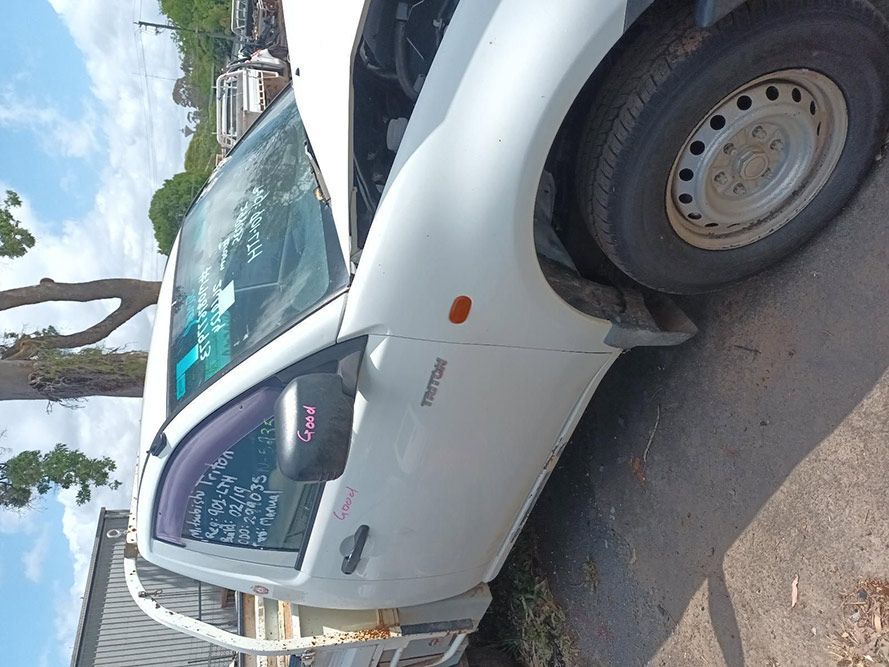 A White Truck is Parked on the Side of the Road — South West 4WD Wreckers In Brisbane, QLD