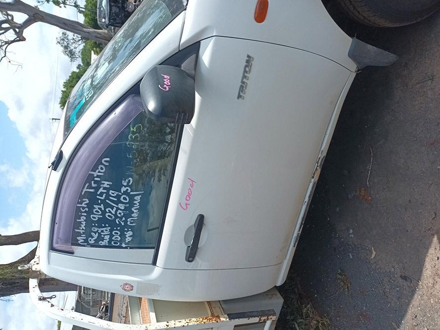 A White Truck is Parked on the Side of the Road — South West 4WD Wreckers In Brisbane, QLD
