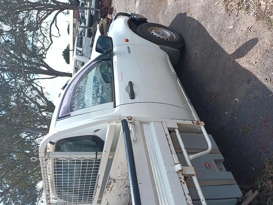 A White Truck is Parked on the Side of the Road — South West 4WD Wreckers In Brisbane, QLD