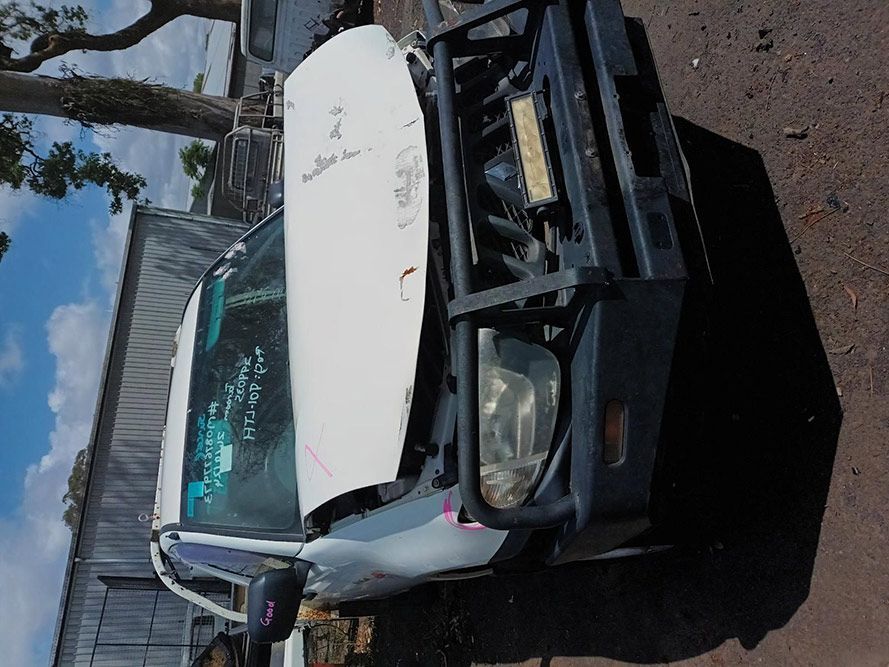 A Car With the Hood Up is Sitting on the Ground — South West 4WD Wreckers In Brisbane, QLD