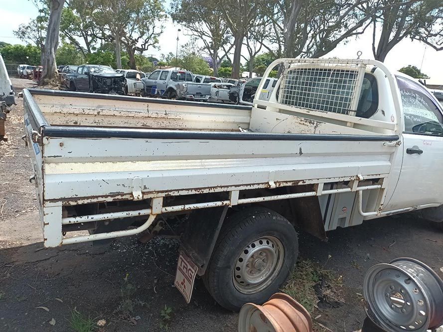 A White Pickup Truck is Parked in a Parking Lot — South West 4WD Wreckers In Brisbane, QLD