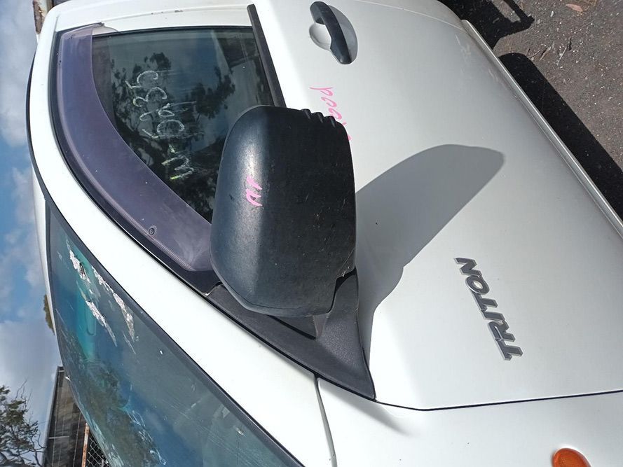 A White Triton Truck is Parked on the Side of the Road — South West 4WD Wreckers In Brisbane, QLD