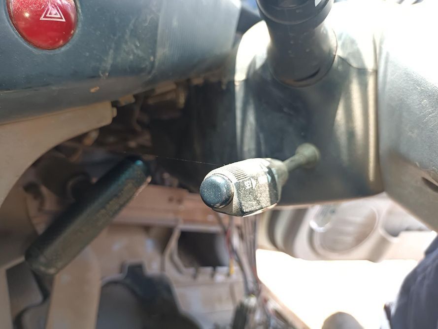 A Close Up of a Steering Wheel With a Red Warning Light in the Background — South West 4WD Wreckers In Brisbane, QLD