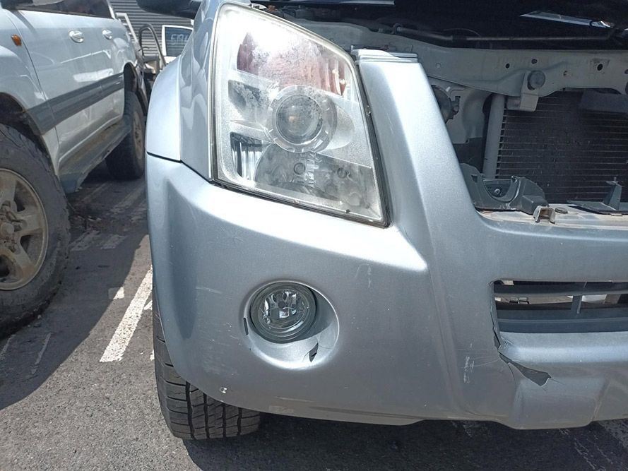 A Silver Car With the Hood Open is Parked in a Parking Lot — South West 4WD Wreckers In Harristown, QLD