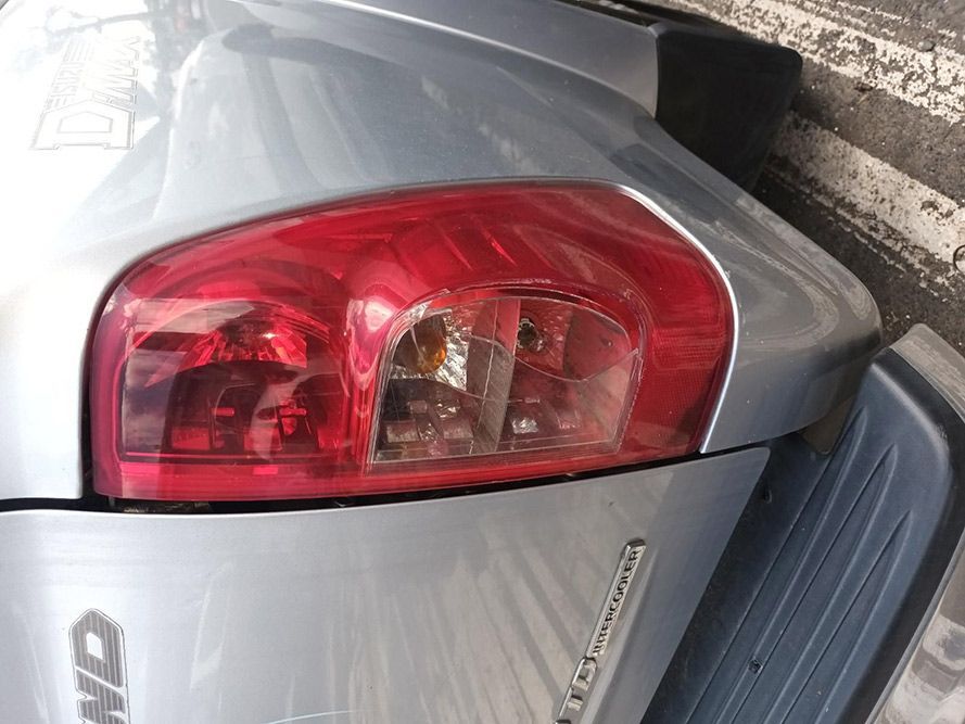 A Silver Car With a Red Tail Light is Parked in a Parking Lot — South West 4WD Wreckers In Harristown, QLD
