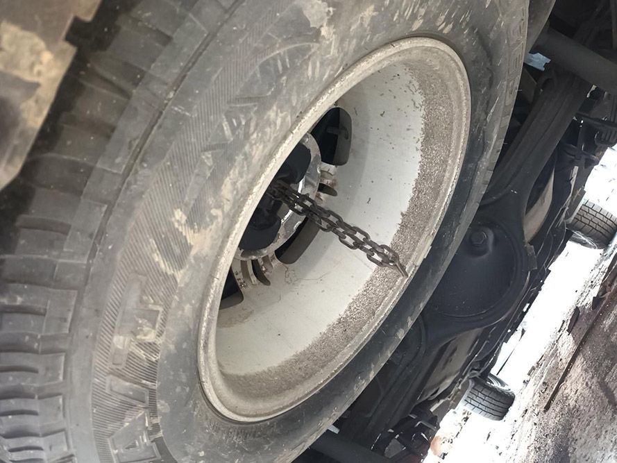 A Close Up of a Tire With a Chain Attached to It — South West 4WD Wreckers In Harristown, QLD