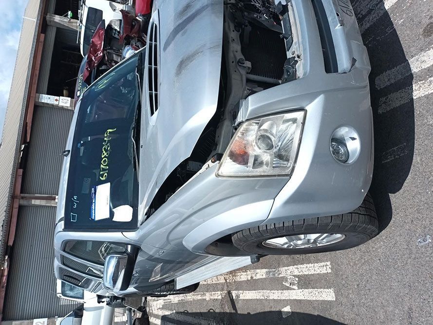 A Silver Truck With the Hood Open is Parked in a Parking Lot — South West 4WD Wreckers In Harristown, QLD