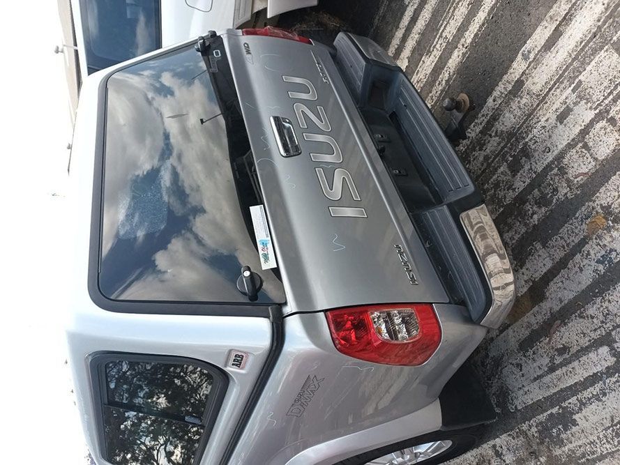 A White Isuzu Truck is Parked in a Parking Lot — South West 4WD Wreckers In Harristown, QLD