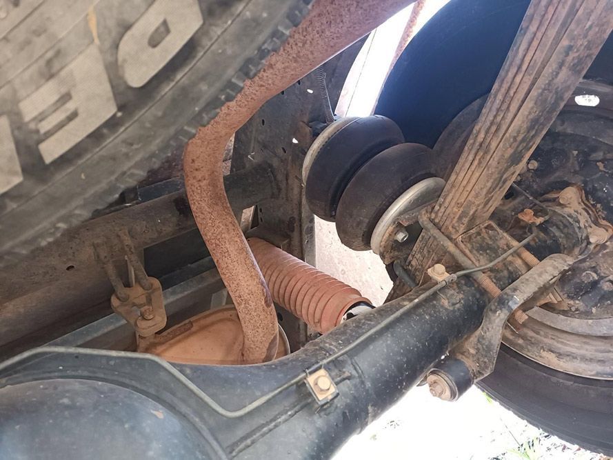 A Close Up of the Underside of a Truck With a Tire on It — South West 4WD Wreckers In Harristown, QLD