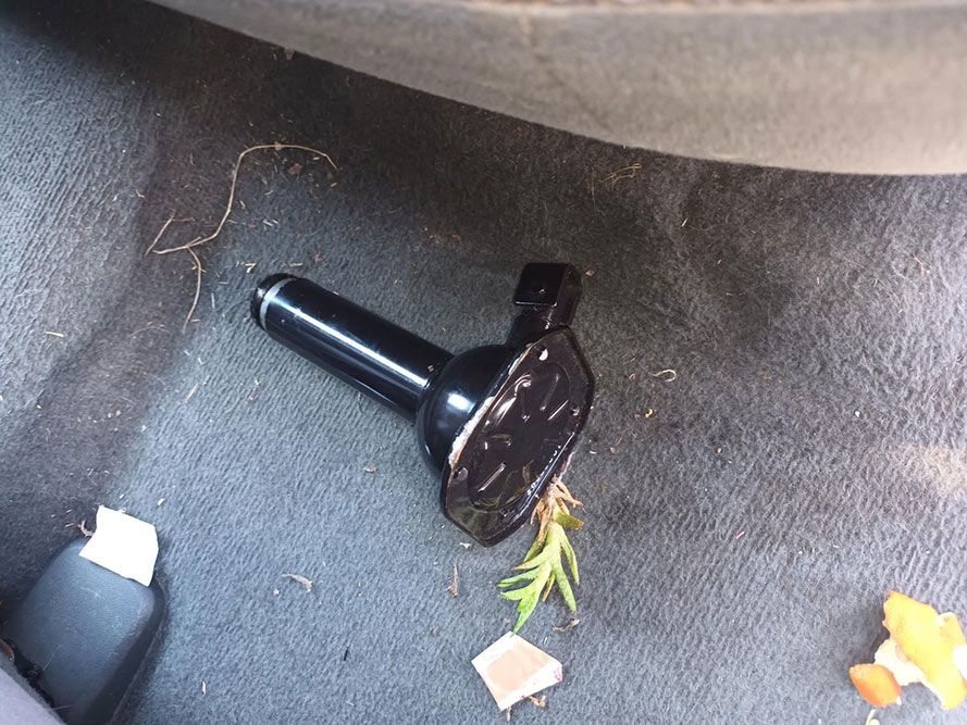 A Black Object is Laying on the Floor Under a Car — South West 4WD Wreckers In Harristown, QLD