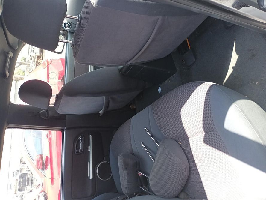 The Back Seat of a Car With a Red Car in the Background — South West 4WD Wreckers In Harristown, QLD