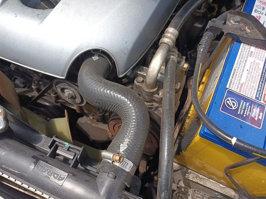 A Close Up of a Car Engine With a Blue Battery — South West 4WD Wreckers In Harristown, QLD
