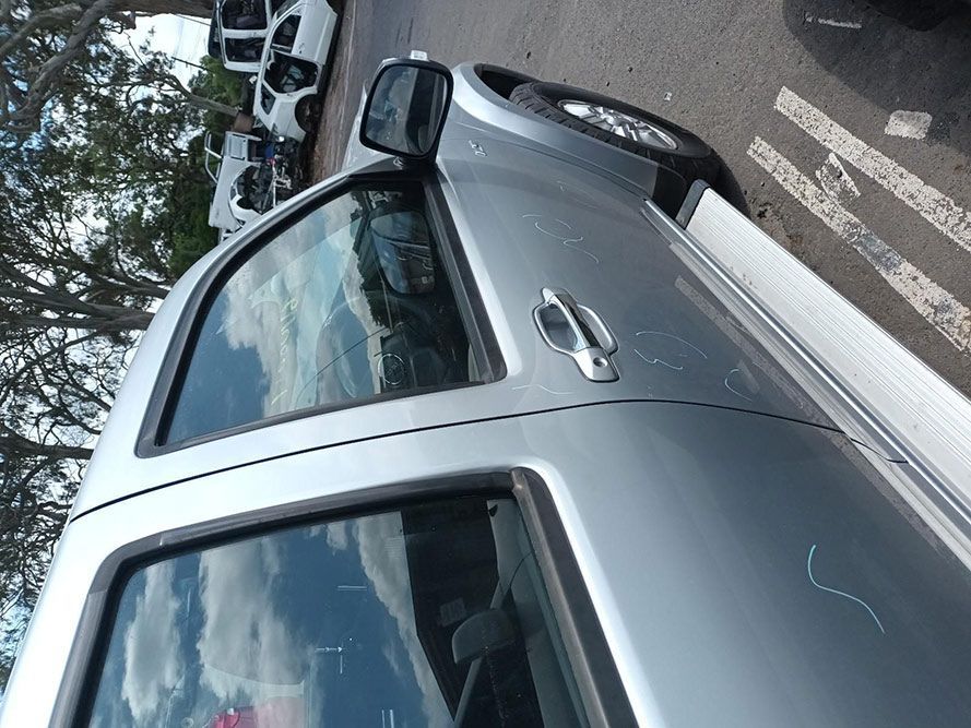 A Silver Truck is Parked on the Side of the Road — South West 4WD Wreckers In Harristown, QLD