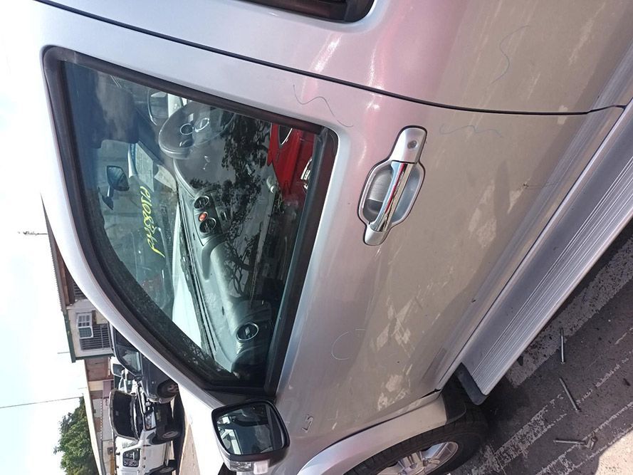 A Silver Truck is Parked on the Side of the Road — South West 4WD Wreckers In Harristown, QLD