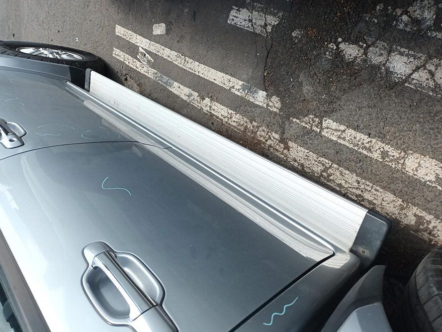 A Silver Car is Parked on the Side of the Road — South West 4WD Wreckers In Harristown, QLD