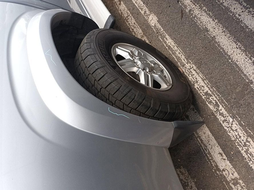 A Tire is Sticking Out of the Fender of a Car — South West 4WD Wreckers In Harristown, QLD