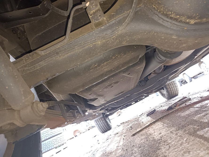 A Close Up of the Underside of a Car in a Parking Lot — South West 4WD Wreckers In Harristown, QLD