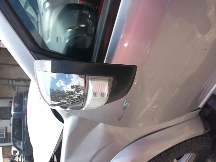 A Silver Car is Parked in a Garage and the Side Mirror is Broken — South West 4WD Wreckers In Harristown, QLD